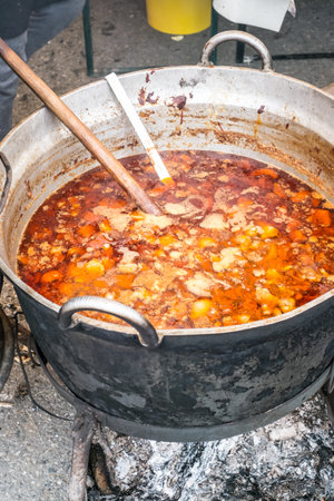 Romanian traditional food prepared at the cauldron on the open fireの写真素材