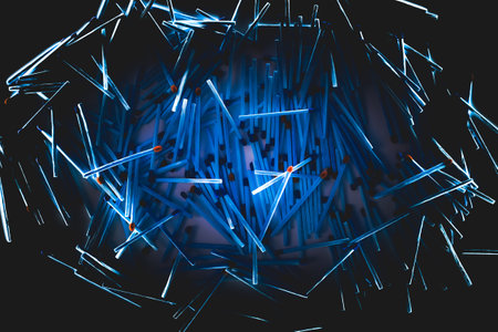 pile of blue matched sticks on dark backgroundの写真素材