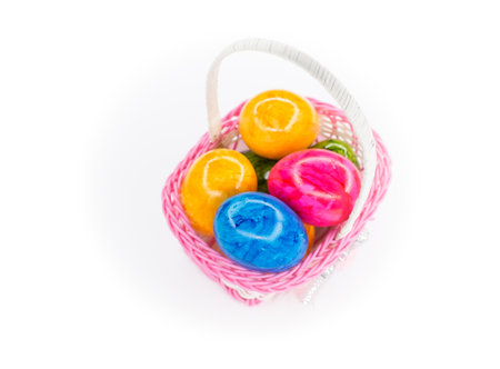 colorful easter eggs in plastic basketの写真素材