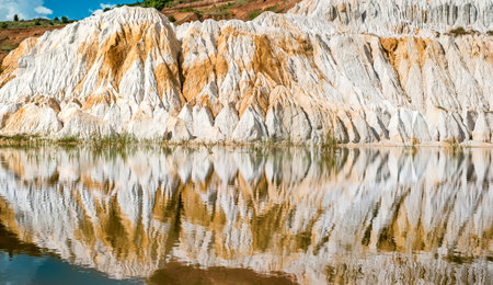 a fragment of a quarry of kaolin mining with beautiful slopes reflecting in the lake, Vetovo village area, Bulgariaの写真素材