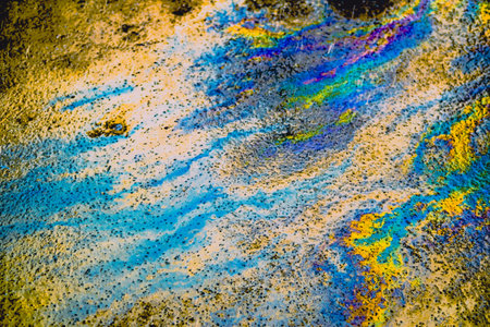 Oil stain on Asphalt road after rain, color Gasoline fuel spots on Asphalt Roadの写真素材