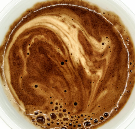 white coffee mug with hot instant coffee foam top viewの写真素材