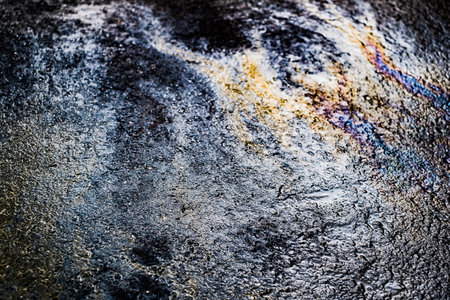 Oil stain on Asphalt road after rain, color Gasoline fuel spots on Asphalt Roadの写真素材