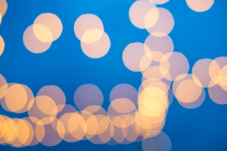 Abstract orange bokeh light texture on  blue backgroundの写真素材
