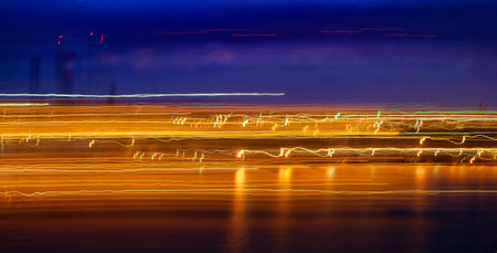 Abstract Light trails on dark background, motion bluredの写真素材