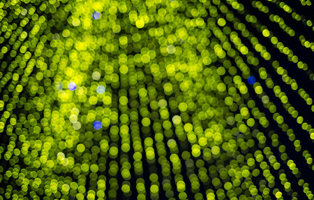 Abstract green bokeh texture on dark backgroundの写真素材