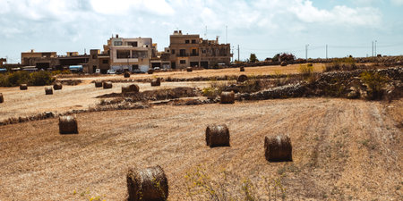 Hill with terraced fields for agriculture and old buildings in Ghajnsielem, Gozo island, Malta