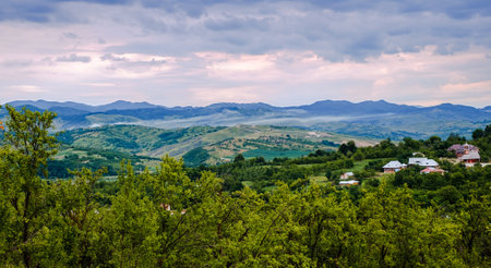Country landscape with apple and plum orchard. Valea Plopului village, Prahova county, Romania.