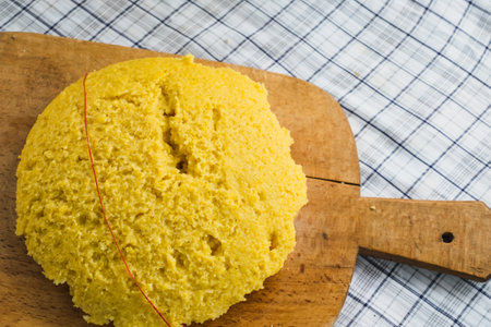 Hot steaming polenta on a old wooden boardの写真素材
