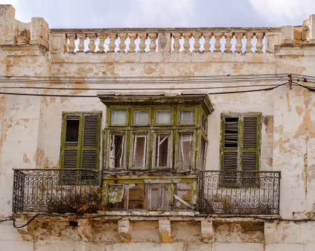 Old ruined window and balcony on a traditional Maltese house.の写真素材