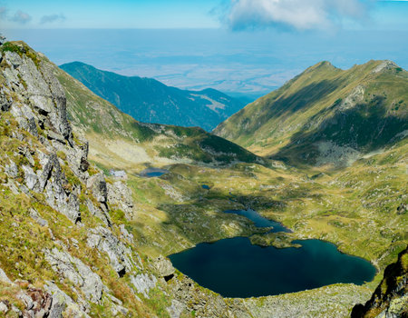 Panoramic view over the Podragului saddle and Podragu cottage, situated in the FÄgÄraÈ Mountains at 2307m high, Romaniaの写真素材