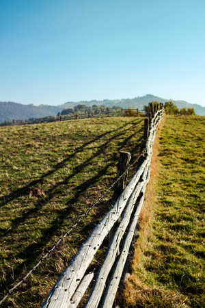 old wooden fence with barbed wireの写真素材