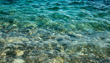 Splashes from the waves bumping against the rocky shoreの写真素材