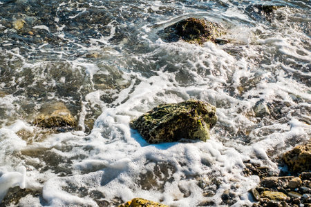 Splashes from the waves bumping against the rocky shoreの写真素材