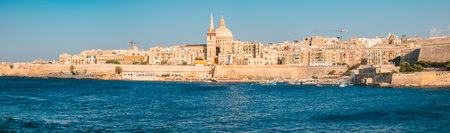 Valletta city, Malta - July 15, 2019, View over the Valletta city from Marsans Harbour at sunsetの写真素材