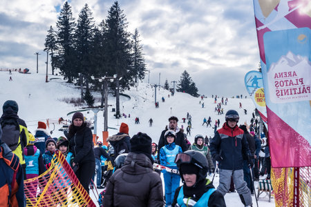 Paltinis Arena Platos, Romania - January 11, 2020. Lots of people on a mountain slope at ski resort in Paltinis Arena Platos. Paltinis Arena Platos is a most popular ski resort in Sibiu, Romaniaのeditorial素材