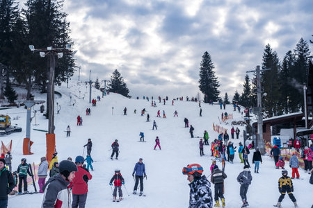 Paltinis Arena Platos, Romania - January 11, 2020. Lots of people on a mountain slope at ski resort in Paltinis Arena Platos. Paltinis Arena Platos is a most popular ski resort in Sibiu, Romaniaのeditorial素材