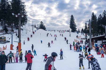 Paltinis Arena Platos, Romania - January 11, 2020. Lots of people on a mountain slope at ski resort in Paltinis Arena Platos. Paltinis Arena Platos is a most popular ski resort in Sibiu, Romaniaのeditorial素材
