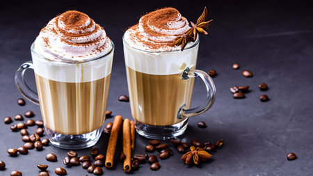 caffe latte with whipped cream, cinnamon and anise in a glassの素材