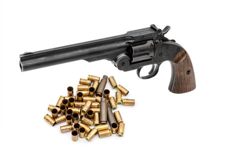 Pneumatic pistol revolver for sports and entertainment with bullet cartridges casings. Airsoft gun on white backgroundの写真素材