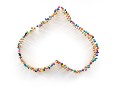 a heart shape made of multicolored matchsticksの写真素材