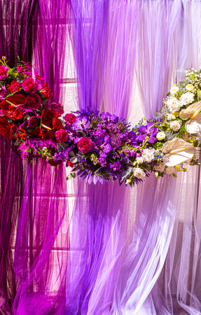 Beautiful backdrop flowers arrangement over purple fabricの写真素材