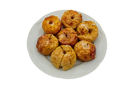 apples baked in the oven with sugar on a plateの写真素材