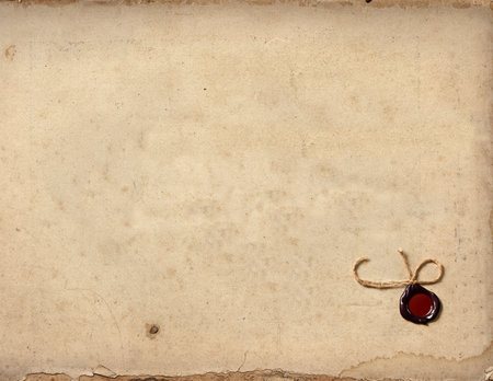 Aging, worn paper with water stains and seal wax with the cordの写真素材