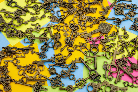 Bronze ornamental keys on a background of multicolored paper sticky notesの写真素材