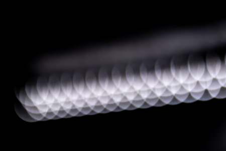 blured defocused led lights on dark backgroundの写真素材