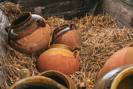 clay pots on dry strawの写真素材