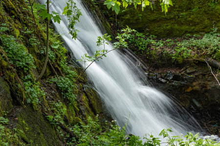 beautiful waterfall in the Cindrel mountains of Romaniaの写真素材