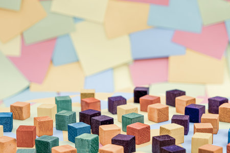 Colorful wood block with a background of multicolored paper sticky notesの写真素材