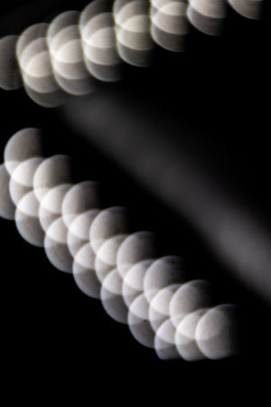 blured defocused led lights on dark backgroundの写真素材