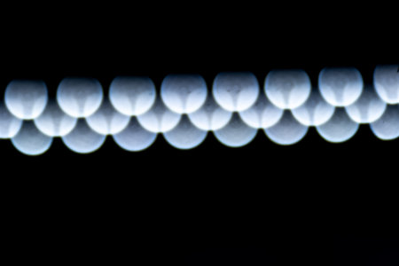 blured defocused led lights on dark backgroundの写真素材