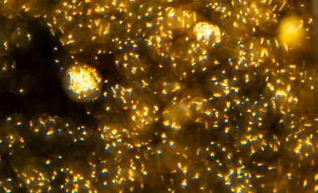 Golden sparkles on black backgroundの写真素材