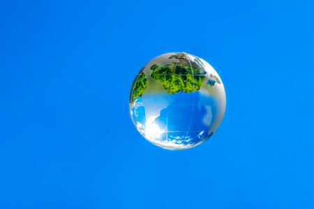 crystal glass globe on a blue skyの写真素材