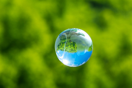 crystal glass globe on a green grassの写真素材