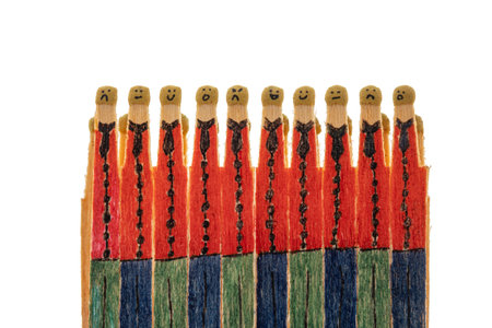 matchsticks with faces painted on the heads on white background