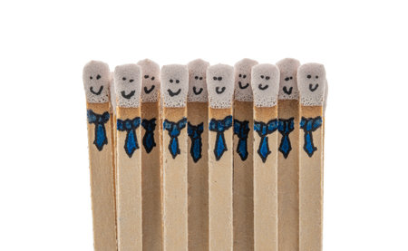 matchsticks with faces painted on the heads on white background