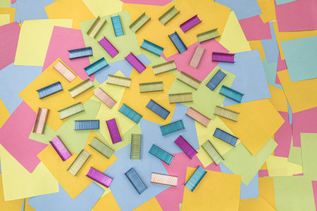 Multicolored office metal staples for stapler on multicolored paper Sticky Notesの写真素材