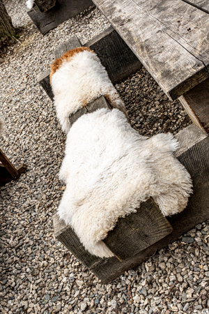 old rustic wooden bench with sheepskinの写真素材