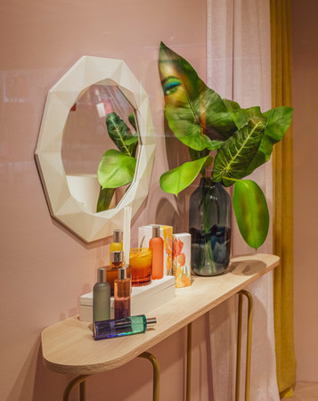 shelf in the bedroom with a mirror, bottles of perfume and balmの写真素材