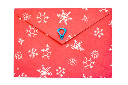 red vintage paper envelope with old metallic soda Can ring pull  and snowflakes isolated on the whiteの写真素材