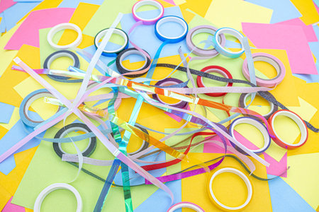 rolls of decorative adhesive tape on a background of multicolored paper sticky notesの写真素材