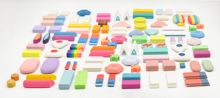 various shapes and colors of erasers arranged isolated on white backgroundの写真素材