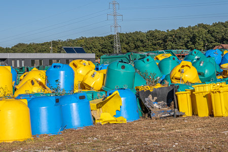 various damaged and discarded recycling containersの写真素材