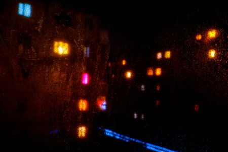 Water drops reflections on the window in nightの写真素材