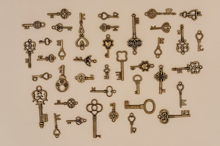 various size and type of Bronze ornamental keys for clocks and treasure boxes arranging at 90 degree angles from each other on  paper backgroundの写真素材