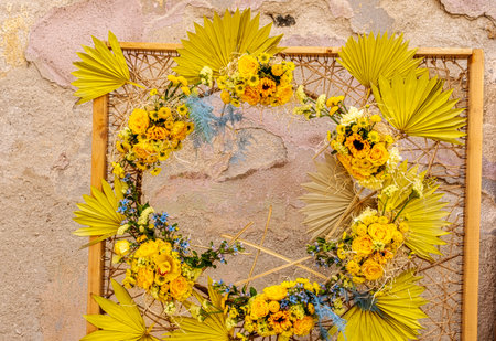 vintage frame decorated with spring flowers on it and old plaster in the backgroundの写真素材